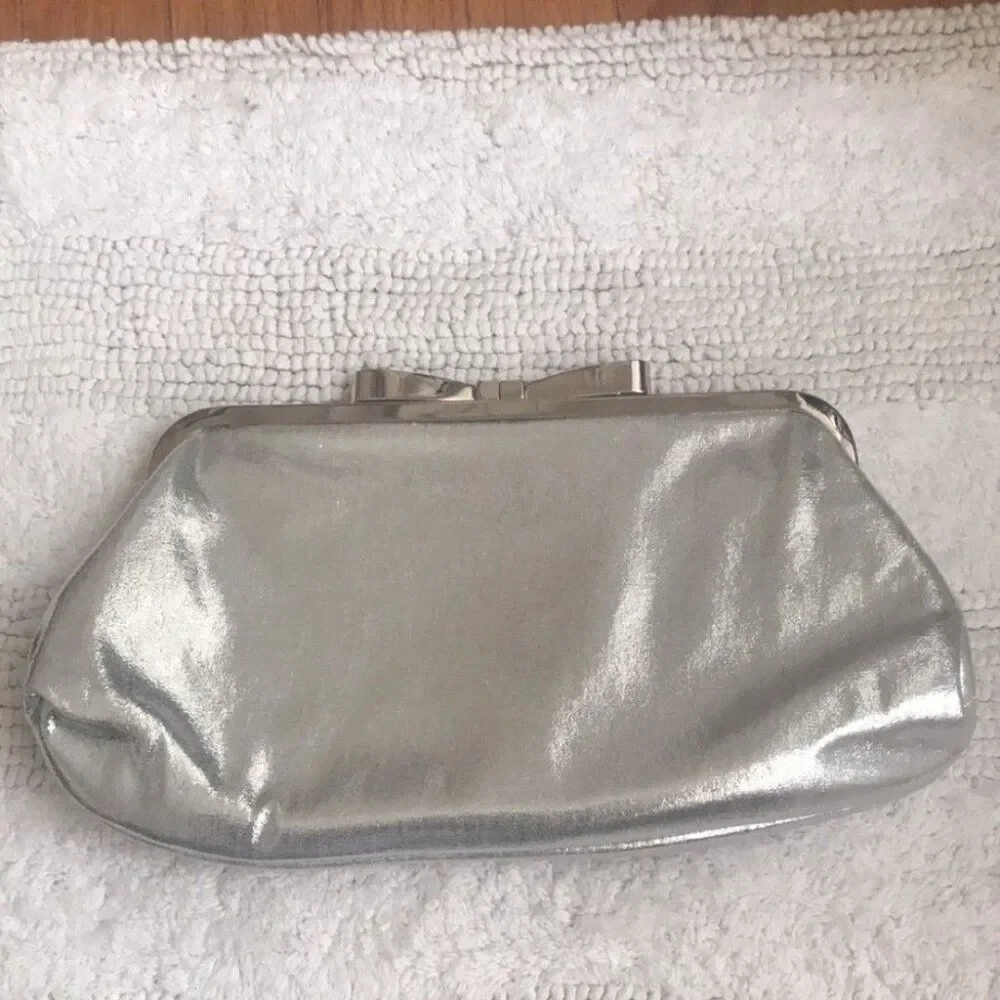 Stunning silver satin like clutch, metallic bow